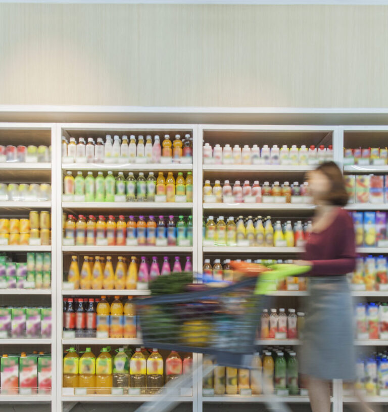 woman pushing shopping cart in supermarket