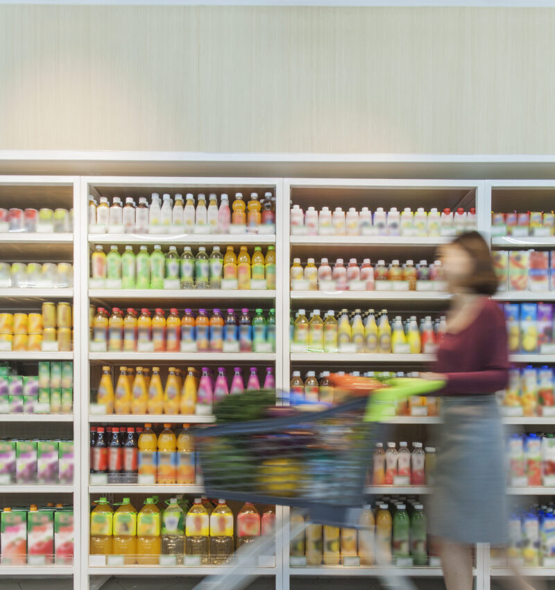 woman pushing shopping cart in supermarket
